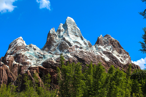A low angle shot of the beautiful Mount Everest at Disney's Animal Kingdom Theme Park under a blue sky