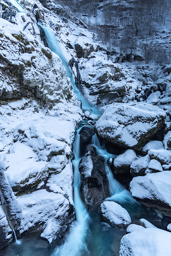 The vertical shot of The Kegon waterfall in the winter, Japan