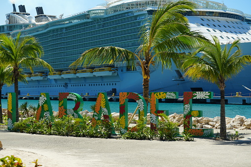 – February 21, 2022: A selective focus shot of the Labadee beach sign with the Allure of the Seas ship in the background