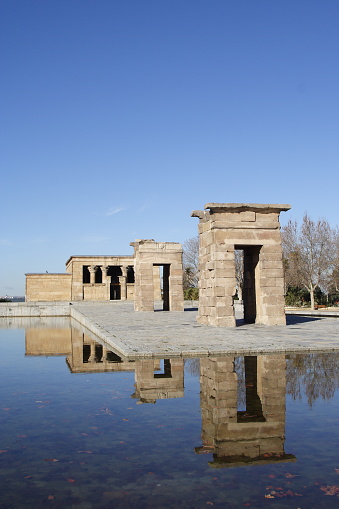 A natural view of the Debod Temple and sky reflecting on the water surface