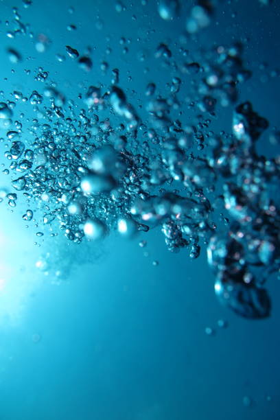 istock Closeup shot of emerging from deep-sea bubbles going towards the sunlight 1436676057
