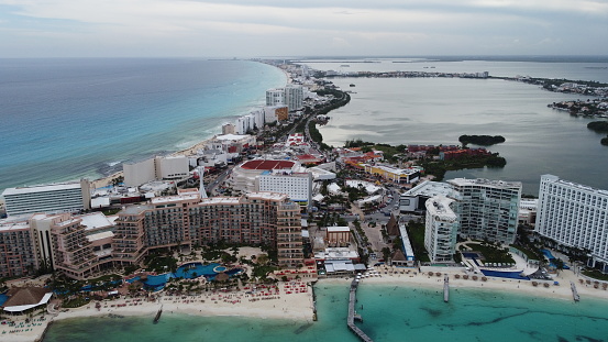 An aerial shot of the Tulum Beach in Mexico with the city surrounded by the turquoise waters of ocean