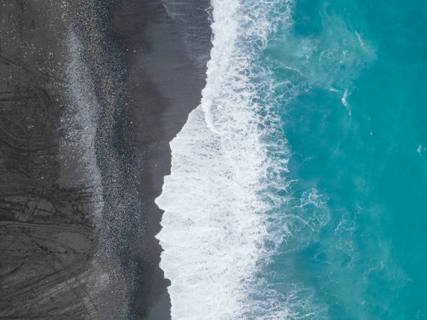 istock Top view of sea waves breaking on an empty sand beach 1436676530