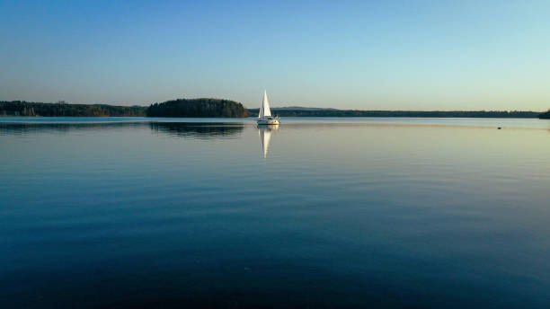 istock Sailing boat on the smooth water surface against the blue sky. Steinberger See, Germany. 1436676748