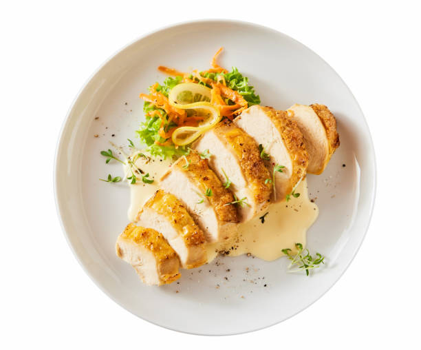 istock Yummy cut chicken breast with vegetables on table 1436676972