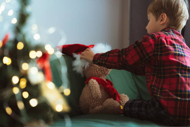 istock cute little boy dressing up teddy bear 1436677903