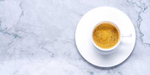 istock Top view shot of strong espresso in a white cup on a marble surface 1436677931