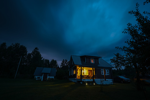 Dwelling exterior scene includes houses with solar panels, night scene . (3d render)