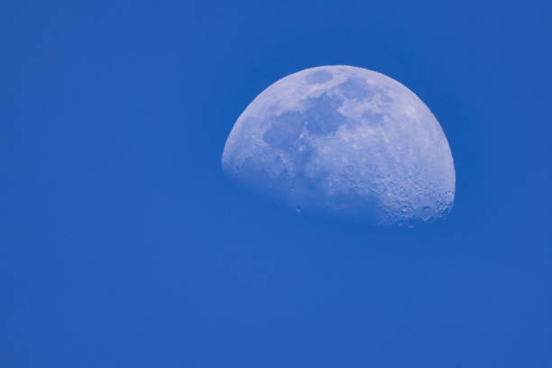 istock Moon fading in a blue sky 1436678703