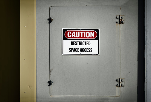 A view of a confined space locked off access door with a \
