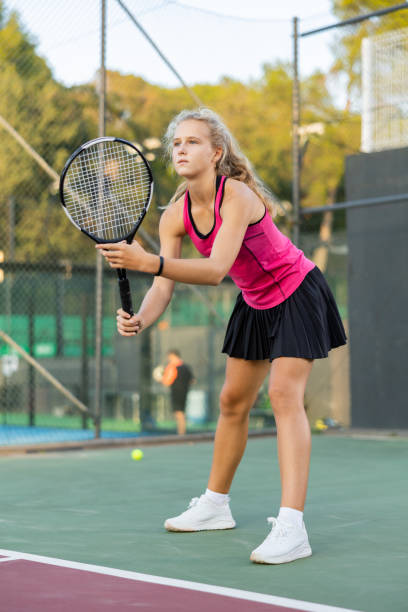 istock Girl playing tennis match during training on court 1436679021