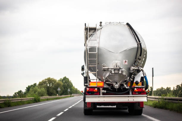 long vehicle truck with tank trailer on a highway. - semi skimmed milk imagens e fotografias de stock