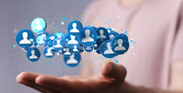 istock Number of blue human profile illustrations above a hand on a blurred background 1436680208