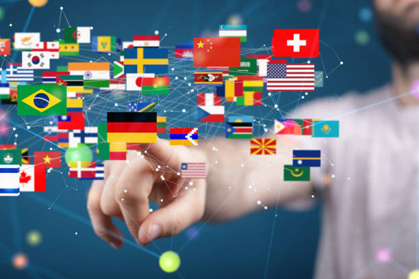 istock Person reaching out to different country flag icons with technological network particles around them 1436680262