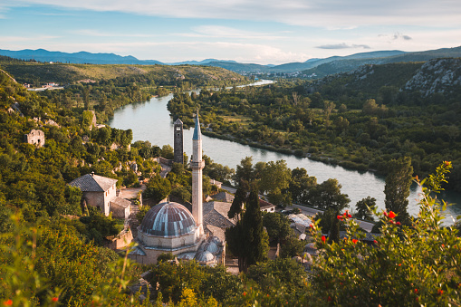 The famous Sisman Ibrahim-immersed Mosque near forested areas and a river in Pocitelj, Bosnia and Herzegovina
