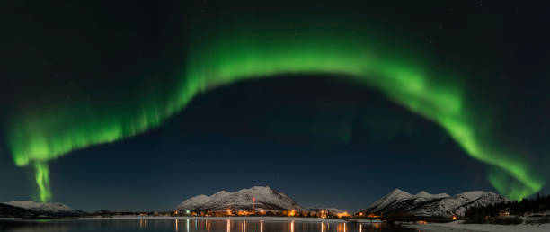 Aurora Borealis over Carcross, Yukon Canada with Bennett lake and reflecting lights