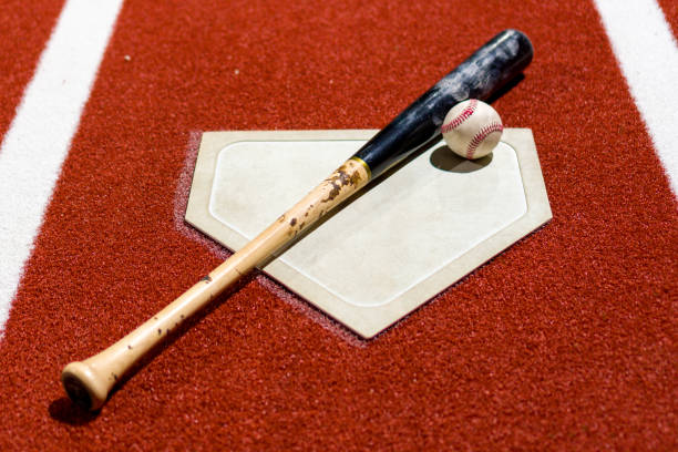 istock High angle shot of a baseball and a bat on the ground 1436682071
