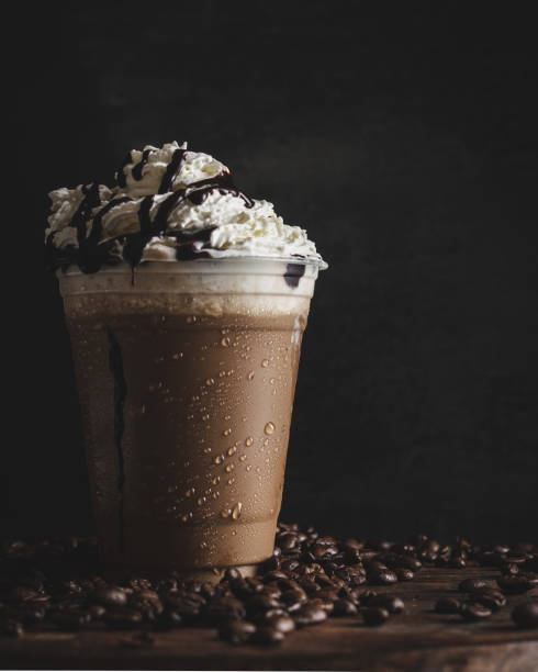 istock Vertical closeup of a plastic cup of cold coffee with a vanilla cream. 1436682532