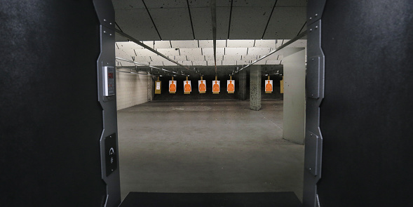 An interior of an empty shooting range with targets - sport