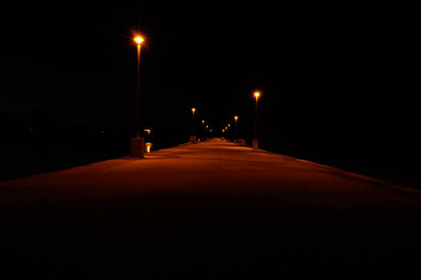 istock Pathway illuminated by outdoor lights against a dark night sky 1436683042