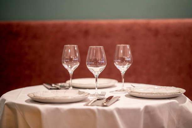 istock Shallow focus beautiful table setting with crockery and glasses for an event in the restaurant 1436683091