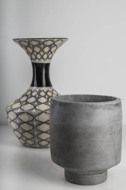 istock Selective focus shot of a small grey ceramic vase and another one with a pattern on the background 1436683112