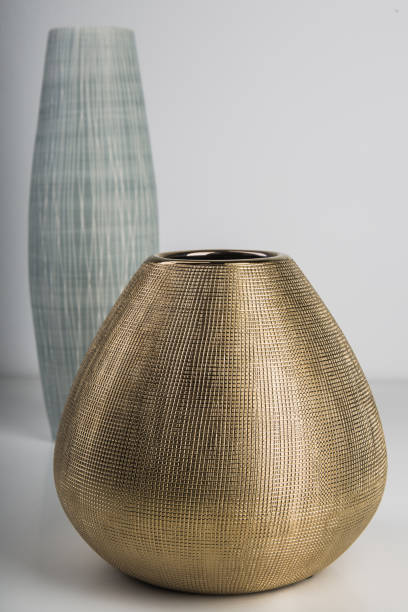 istock Selective focus shot of a golden ceramic vase on a grey surface 1436683153