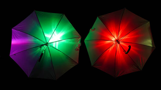 Colorful illuminated umbrellas isolated on a dark background