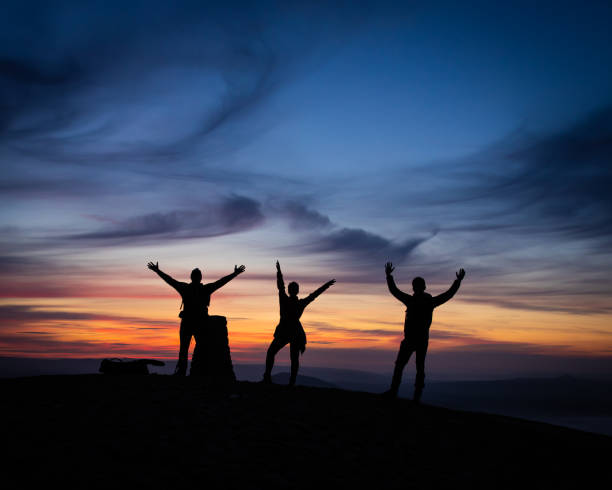 istock Silhouette of mountain climbers with the sunset background 1436684247