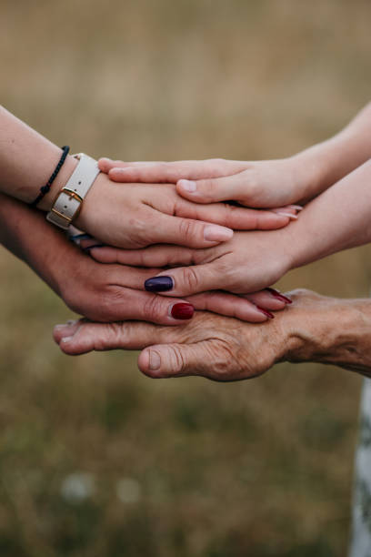 istock Closeup shot of women's hands from different generations together 1436684441