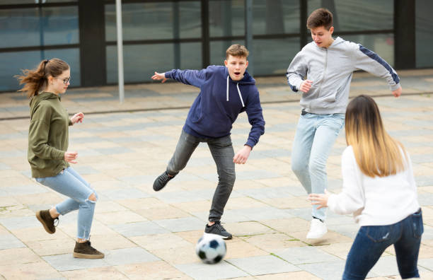 istock Teenagers playing soccer with ball outside 1436685821