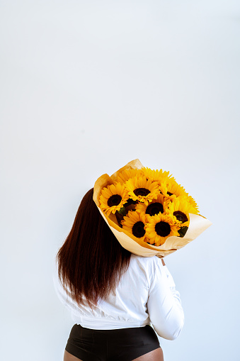Girl Holding Sunflowers