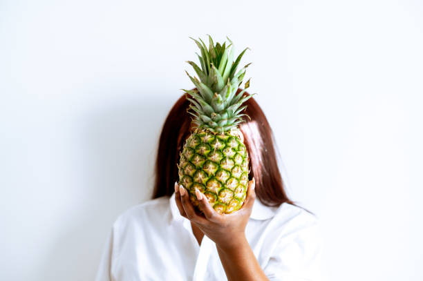 istock Black Woman Holding Pineapple In Front of Face 1436686148