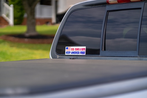 A pro 2nd Amendment sticker on the back  window of a pickup truck