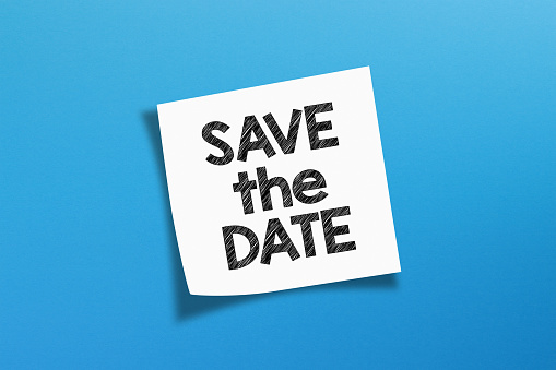 Save the date. save the date message with white note paper on blue background.