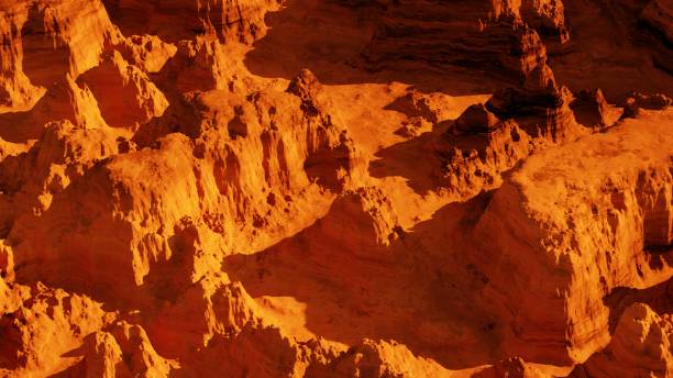 istock 3d render of imaginary mars planet terrain, Mars planet landscape, orange eroded desert with mountains and sun, realistic science fiction illustration. 1436688264
