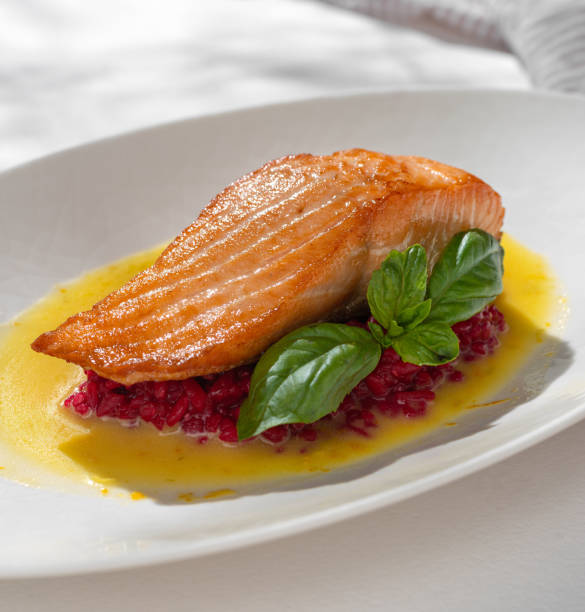 istock Salmon Steak with red Risotto on white background 1436688282
