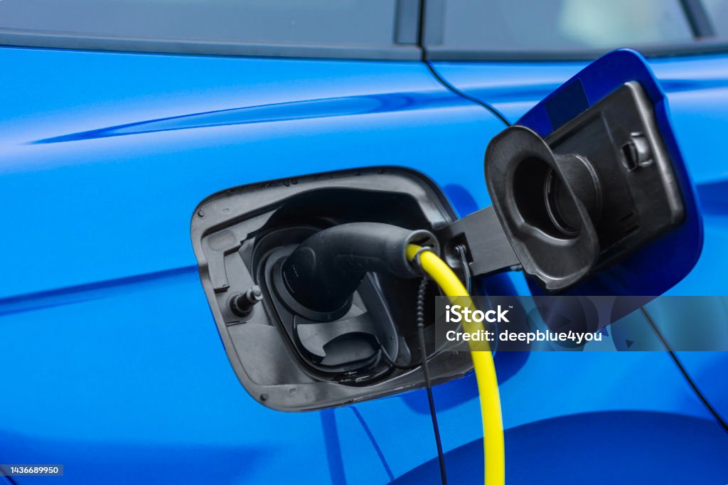 Blue hybrid SUV at the charging station Electric Car Stock Photo