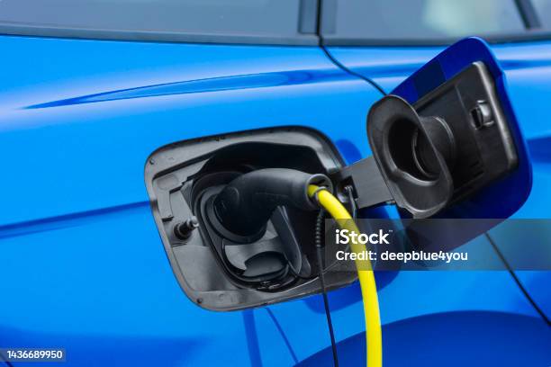 Blue Hybrid Suv At The Charging Station Stock Photo - Download Image Now - Electric Car, Charging, Electric Vehicle Charging Station