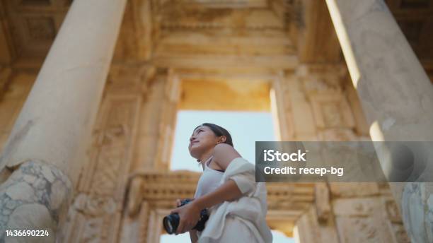 Young Female Tourist Taking Photos And Videos In Historical Ancient Town Stock Photo - Download Image Now