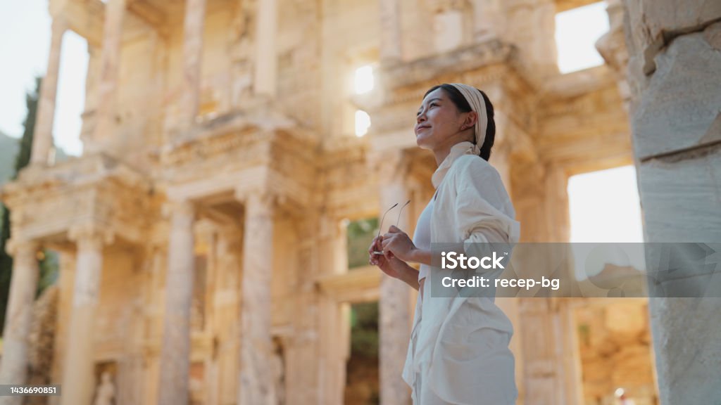 Portrait of female young tourist in historical ancient old town A portrait of a female young tourist in a historical ancient old town. Ephesus Stock Photo