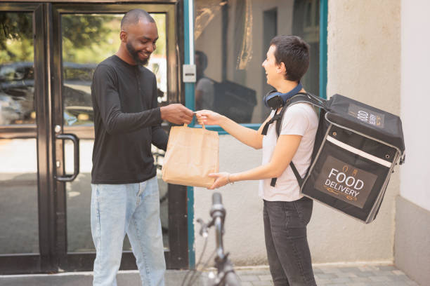 istock Express office food delivery service, courier giving client lunch 1436691179
