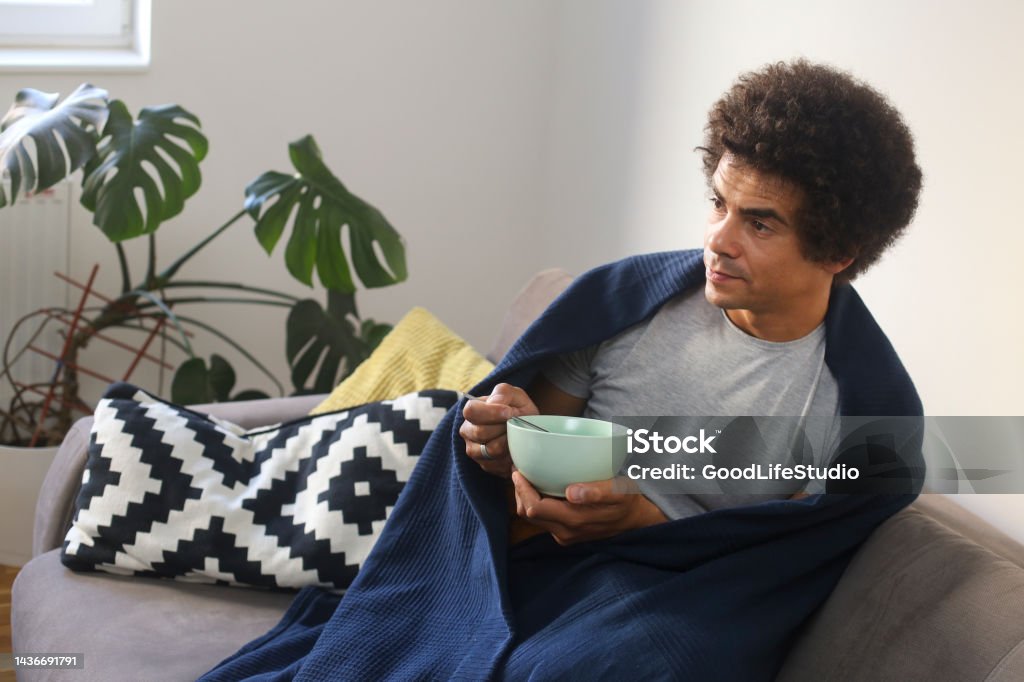 Hot soup Mid adult man with a flu at home. About 35 years old mixed-race male. 30-34 Years Stock Photo
