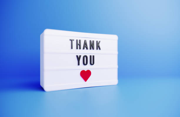 istock Thank You Written White Lightbox Sitting On Blue Background 1436693963