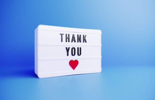 Thank You career written white lightbox sitting on blue background. Horizontal composition with copy space.