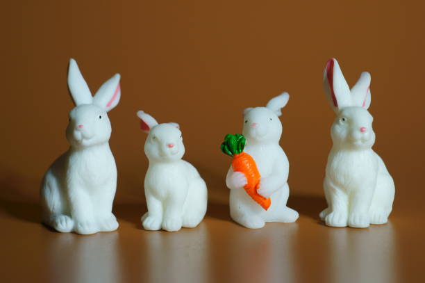 istock Toy rabbits on a brown background. Bright colored background. 1436695408