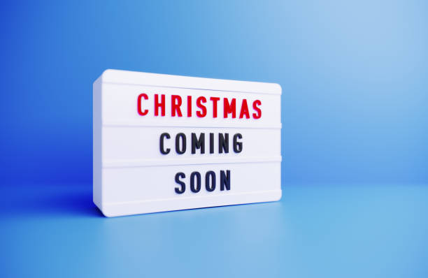 istock Christmas Coming Soon Written White Lightbox Sitting On Blue Background 1436695441
