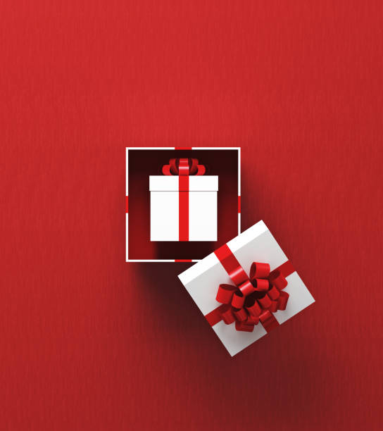 istock White Gift Box Is Sitting Inside Of Another Gift Box On Red Background 1436695602