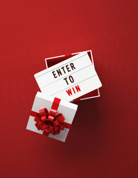 istock Enter To Win Written Lightbox Sitting Over White Gift Box On Red Background 1436695801