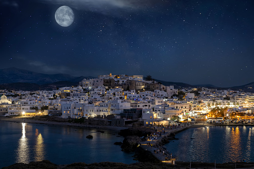 The city of Naxos island, Cyclades, Greece, during a beautiful summer night with full moon and stars in the sky